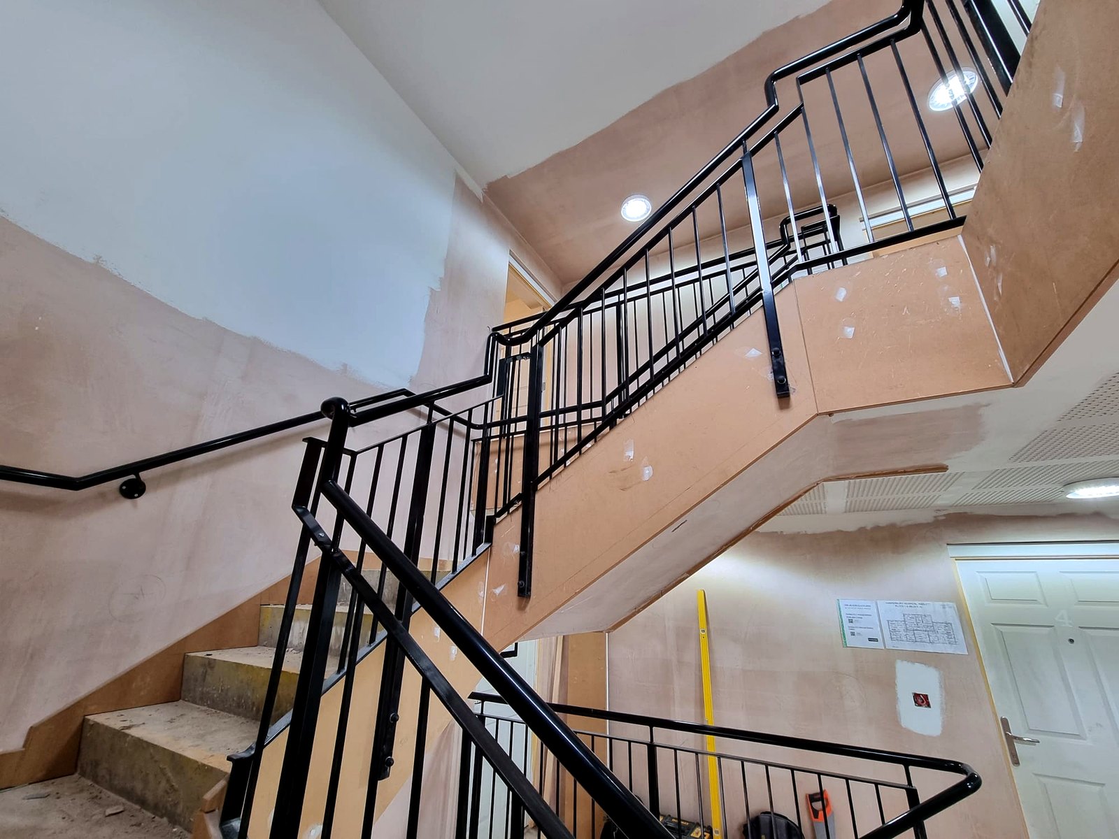 Powder-coated bar-infill metal balustrade to a communal apartment staircase, Radlett